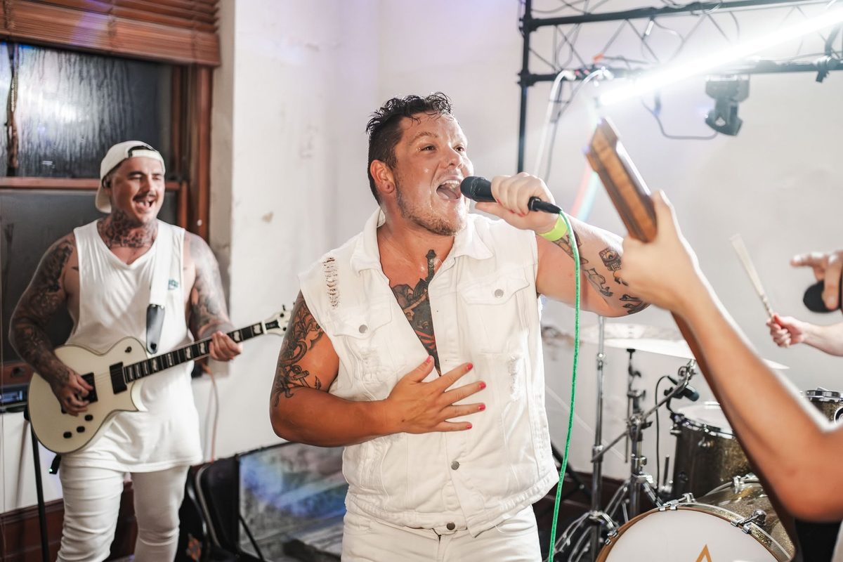 New Anomaly frontman screaming into the mic at a packed room show